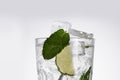 Glass of lemonade with lemon, lime and mint on white background.  Soda water with citrus and ice. Lime and orange in sparkling Royalty Free Stock Photo