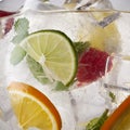 Glass of lemonade with lemon, lime and mint on white background.  Soda water with citrus and ice. Lime and orange in sparkling Royalty Free Stock Photo