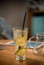 Glass lemonade lime coctail cold drinks fresh fruits table cafe restaurant bokeh