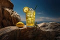Glass of lemonade on the top of rocks in sunset Royalty Free Stock Photo
