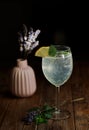 A glass of lemonade and a vase of lavender on the background with wooden texture Royalty Free Stock Photo