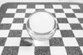 Glass lens ball on a marble chess board, soft focus close up Royalty Free Stock Photo