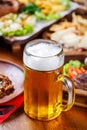 A glass of light beer on the background of a table with snacks. Royalty Free Stock Photo