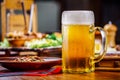 A glass of light beer on the background of a table with snacks. Royalty Free Stock Photo