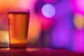 A glass of light beer on the bar in a bright colorful setting Royalty Free Stock Photo