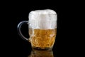 A glass of light beer on a black background with reflection Royalty Free Stock Photo