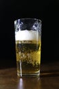 Glass of light beer on a dark background. Royalty Free Stock Photo
