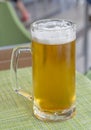 Glass of light beer on a dark pub Royalty Free Stock Photo