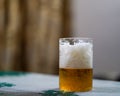 Glass of light beer on a dark pub Royalty Free Stock Photo