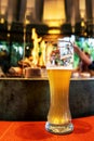 Glass of light beer in a dark pub Royalty Free Stock Photo