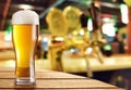 Glass of light beer on a dark pub. Royalty Free Stock Photo