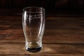 Glass of light beer on a dark pub. Glass beer on wood background with copy space Royalty Free Stock Photo