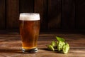 Glass of light beer on a dark pub. Glass beer on wood background with copy space Royalty Free Stock Photo