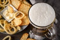 Glass of light beer with foam, onion rings, cracker and cheese sauce top view, beer with snacks Royalty Free Stock Photo