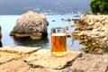 Glass of light beer near sea. Misted mug, pint of cold beer stands against background of blurred sea and mountain landscape in Royalty Free Stock Photo