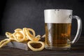 Glass of light beer with onion rings Royalty Free Stock Photo