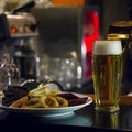The glass of light beer and plate of snacks on the bar Royalty Free Stock Photo