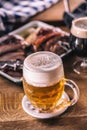 Glass of light beer in pub or restavurant on table with delicoius food Royalty Free Stock Photo