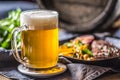 Glass of light beer in pub or restavurant on table with delicoius food Royalty Free Stock Photo