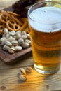 A glass of light beer and snacks on a dark background Royalty Free Stock Photo