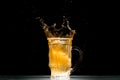 glass of light  beer with splashes at table on black background Royalty Free Stock Photo