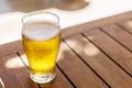 Glass of light beer on the wooden table. Royalty Free Stock Photo