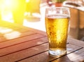 Glass of light beer on the wooden table Royalty Free Stock Photo