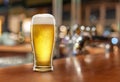 Glass with light beer on a wooden table against the backdrop of a dark pub. Beer vintage concept Royalty Free Stock Photo