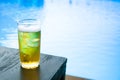 Glass of the light beer on the wooden table at pool Royalty Free Stock Photo