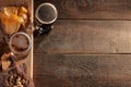 A glass of light and a glass of dark beer and snacks on a wooden brown table with a place for inscription. Royalty Free Stock Photo