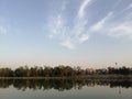 Glass like waters of Sanjay Lake reflecting trees and buildings