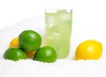 Glass of lime juice with ice cubes,limes,lemons on snow on white Royalty Free Stock Photo