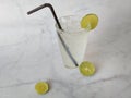 Glass of lime soda on marble background