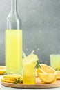 Glass of limoncello traditional Italian alcoholic drink. Freeze motion splash drops of liqueur. vertical image. place for text