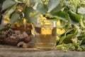 Glass of linden tea with brown sugar and flowers on wooden table Royalty Free Stock Photo