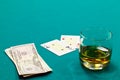 A glass of liquor and cards and dollars Royalty Free Stock Photo