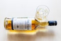 Glass and lying bottle of Talisker Scotch whisky