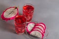 Glass of mango dragonfruit refresher drink on grey table with ice cubes. Copy space Royalty Free Stock Photo