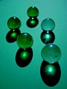 Glass marble balls on green background Royalty Free Stock Photo