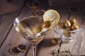 Glass of martini with green olives on a old wooden table Royalty Free Stock Photo