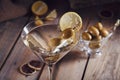 Glass of martini with green olives on a old wooden table Royalty Free Stock Photo