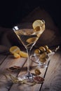 Glass of martini with green olives on a old wooden table Royalty Free Stock Photo