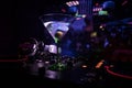 Glass with martini with olive inside on dj controller in night club. Dj Console with club drink at music party in nightclub with d