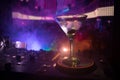 Glass with martini with olive inside on dj controller in night club. Dj Console with club drink at music party in nightclub with d