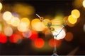 Martini in glass with olives on bokeh background