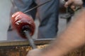 Glass master while working in Murano furnace glass factory Venice Italy