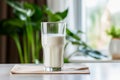 A glass of milk in a beautiful modern kitchen. The benefits of calcium and dairy products