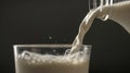 A glass of milk is being poured into a black background Generative AI Royalty Free Stock Photo