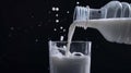A glass of milk being poured into a bottle Generative AI Royalty Free Stock Photo
