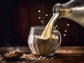 Glass of milk is being poured into a cup Royalty Free Stock Photo